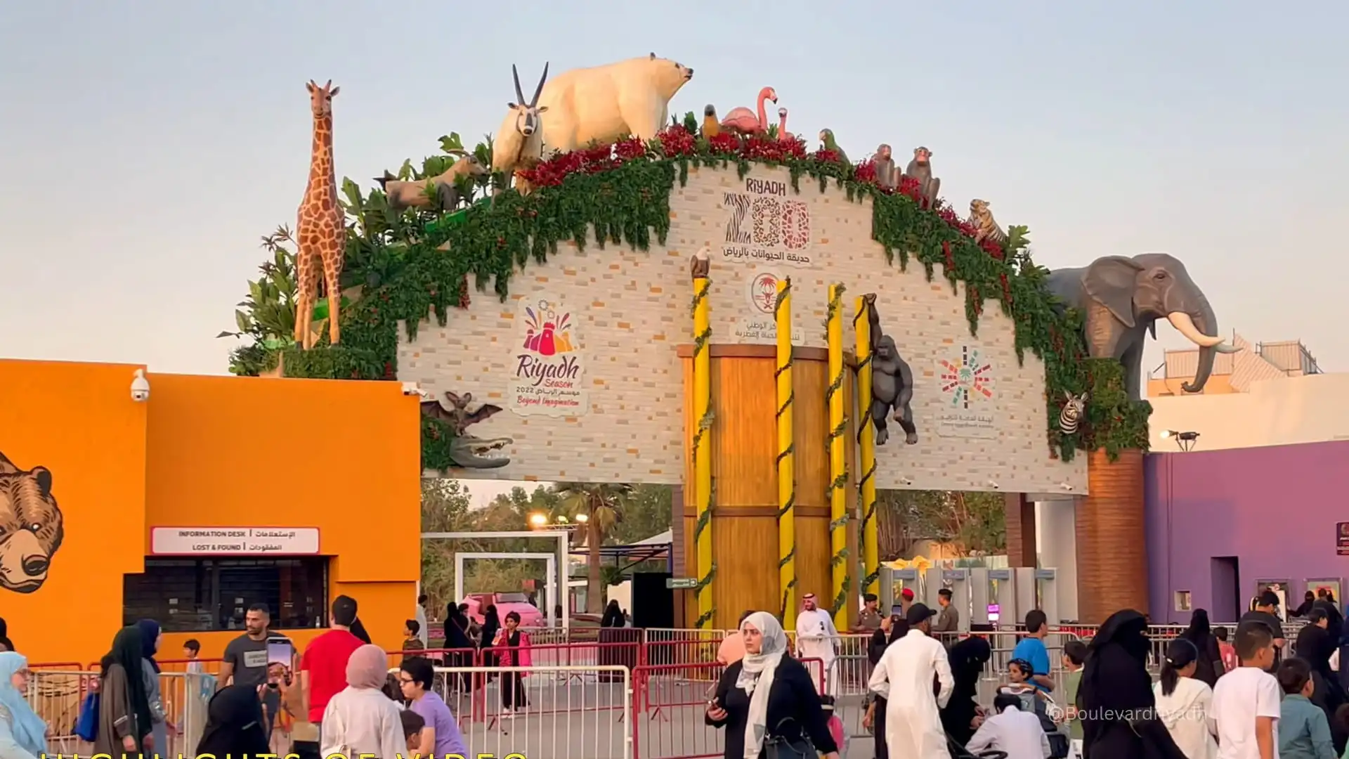Riyadh Zoo walkway with families and animal exhibits